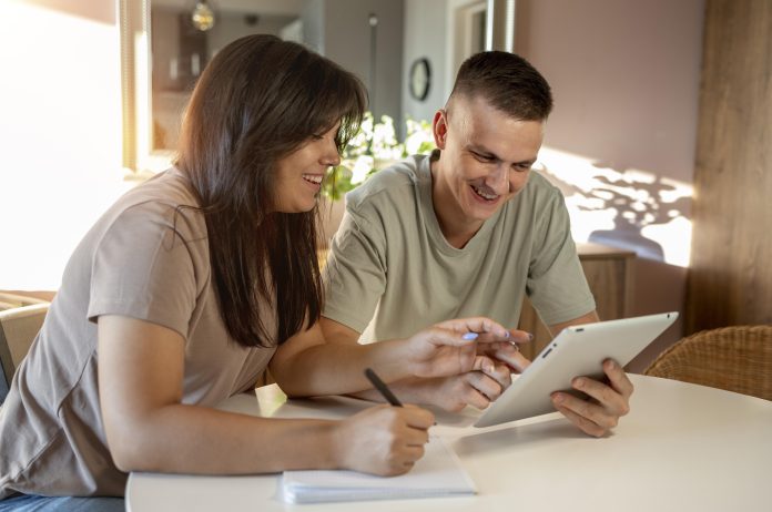 man-woman-making-shopping-list-with-tablet